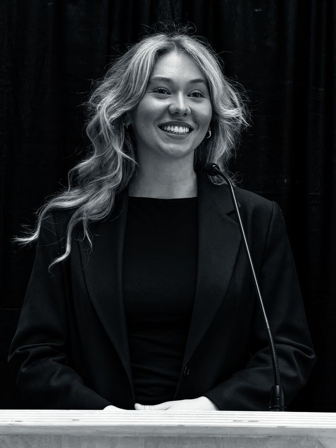 Aleah Kamerman speaking at a podium at RRC Polytech during a communications presentation