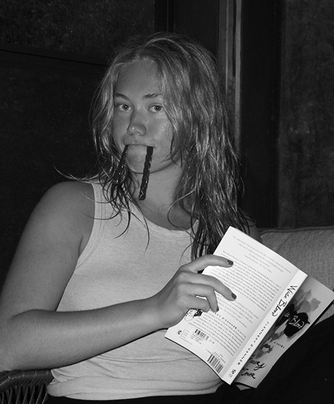 Aleah Kamerman smiling headshot in black and white with tie